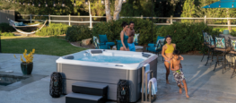 A family enjoys an afternoon soak in Hot Spring Spas Relay, a 6-person value-priced hot tub.