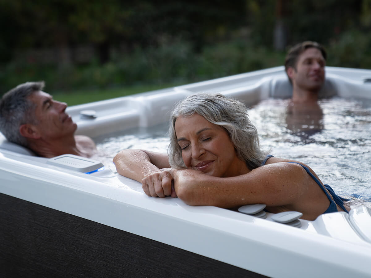 Family relishes a relaxing soak in their cutting-edge salt water hot tub from Hot Spring Spas.