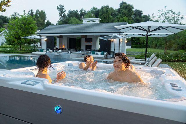 A group of friends enjoying summer afternoon, soaking in a hot tub and sharing laughter.
