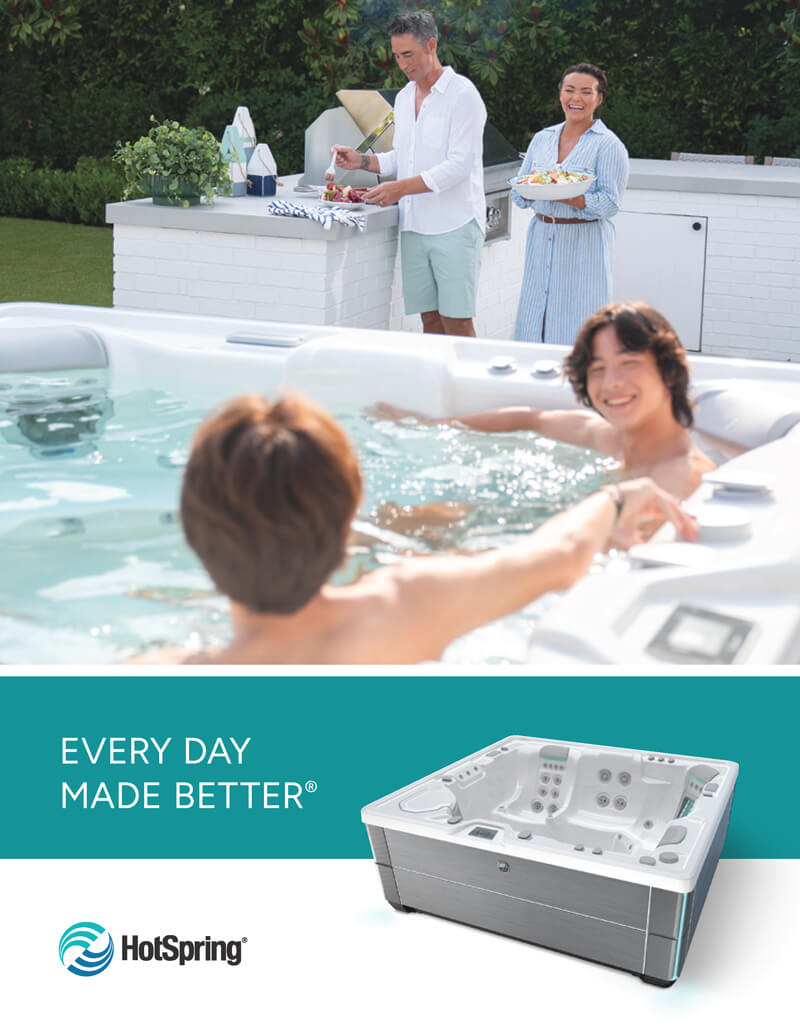 A family enjoying a HotSpring hot tub outdoors while two adults prepare food at a backyard kitchen nearby, with the tagline 'Every Day Made Better' and a product shot of a white HotSpring spa.